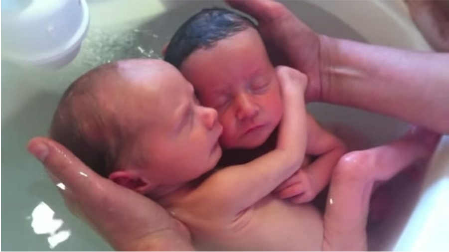 Newborn twins won’t stop cuddling like they did in the womb